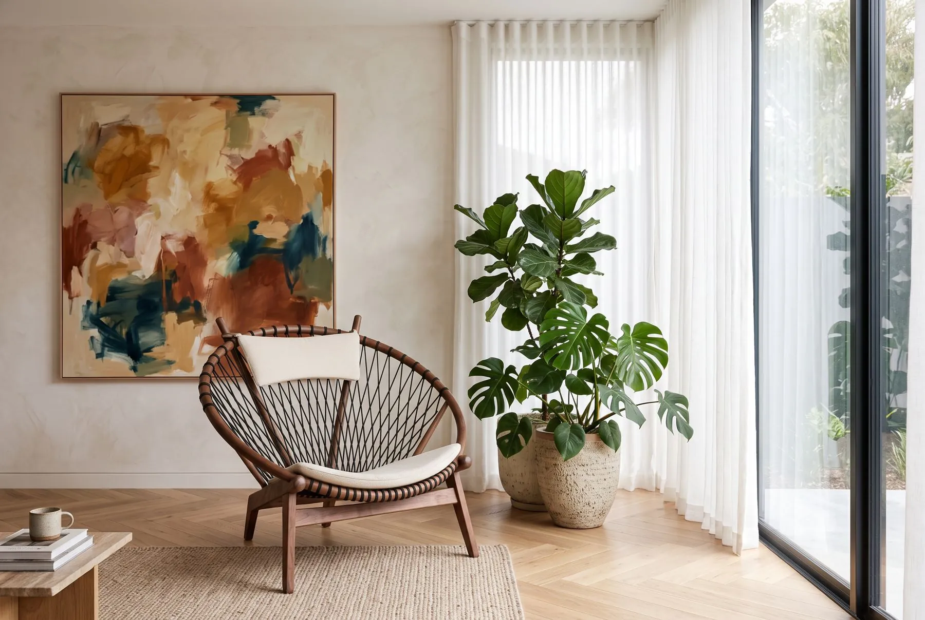 Lifestyle image of a living room with a wood and rope lounge chair