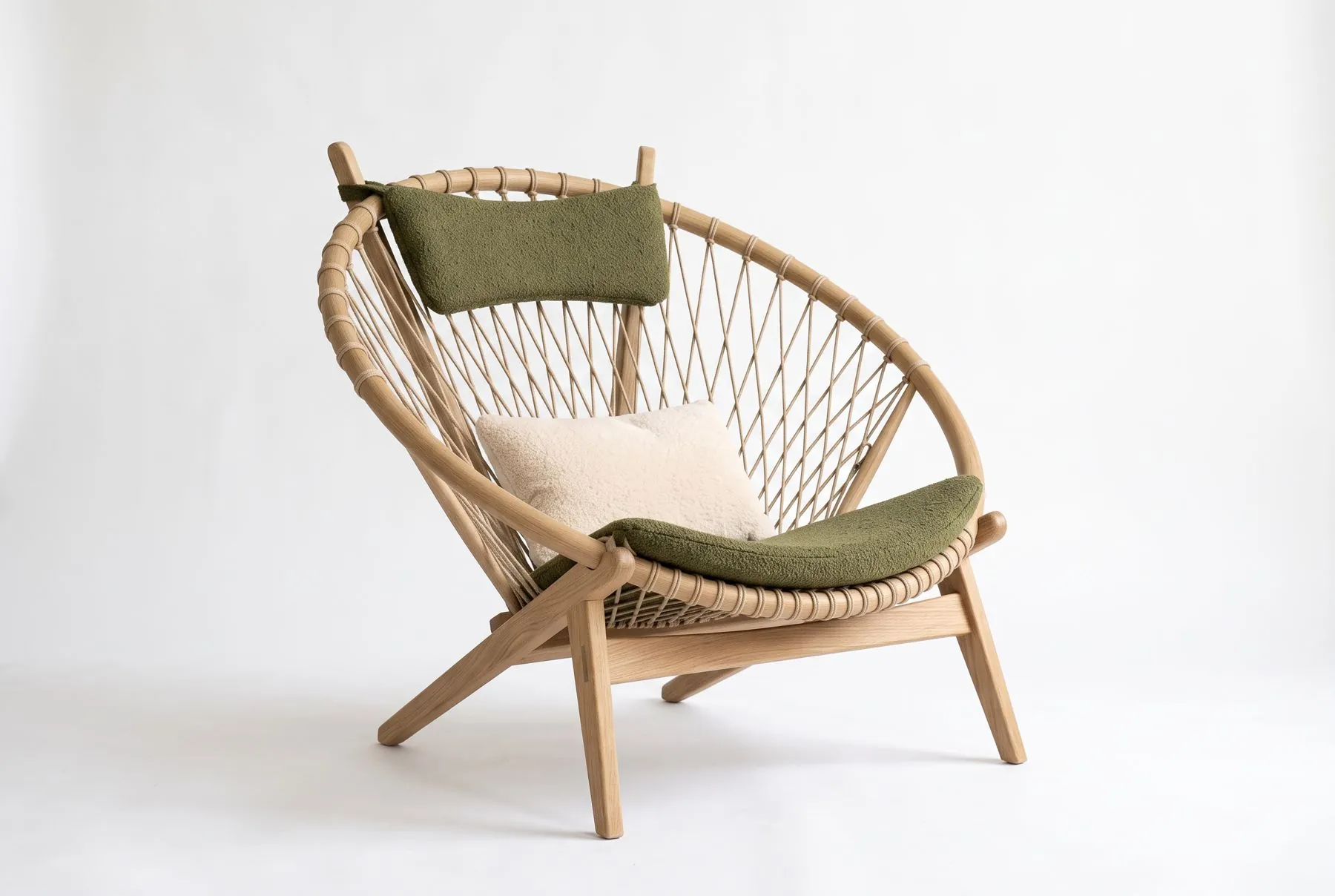 Natural oak lounge chair with olive green cushions, studio shot