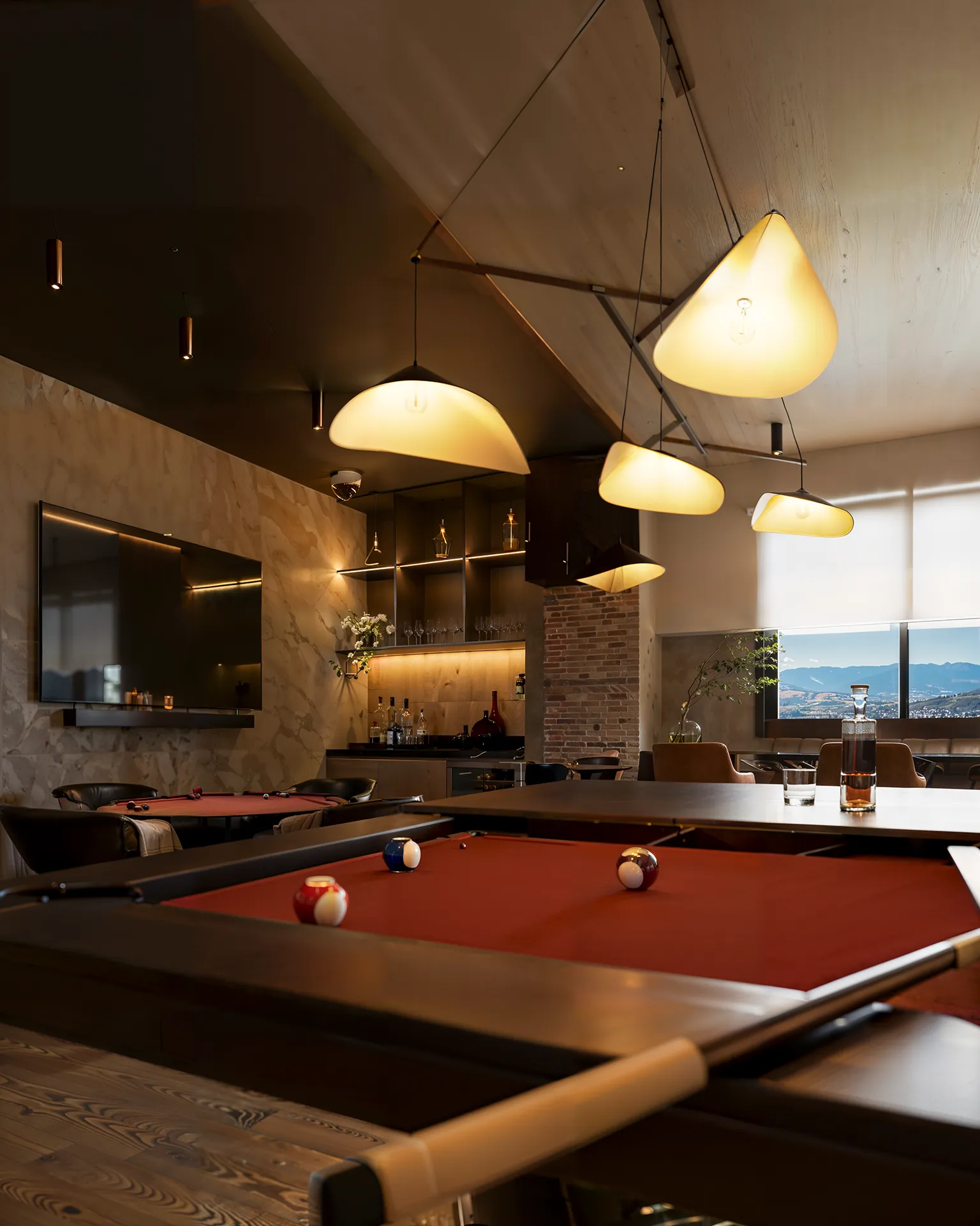 Liv Green Residence, salão de jogos em render 3D visto da borda da sinuca, com TV, mesa de carteado e bar iluminado