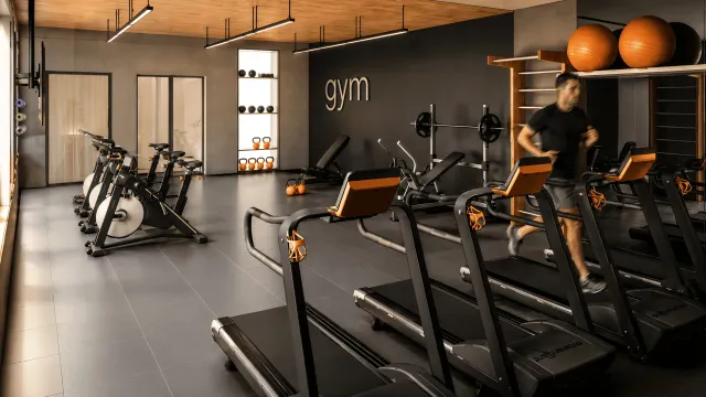 Academia do condomínio Volare em Eusébio, CE, em render 3D, com esteiras, bikes ergométricas e parede preta
