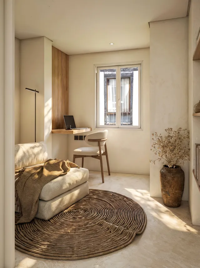 Render 3D do Apartamento Madrid: cantinho de leitura banhado pelo sol da tarde, cadeira estofada e vaso com flores secas